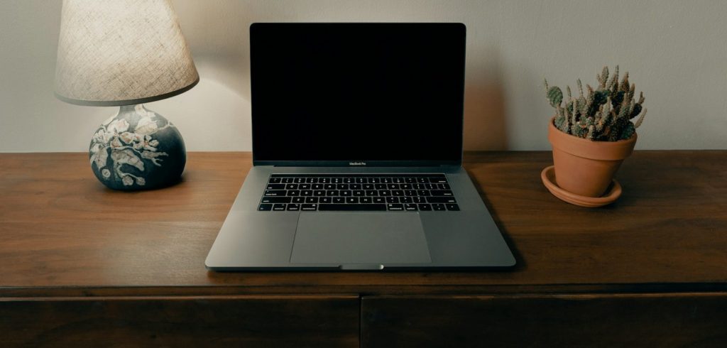 Macbook pro on brown wooden table